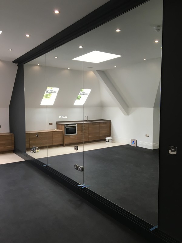 Frameless glass partition in loft conversion by Chelsea glaziers