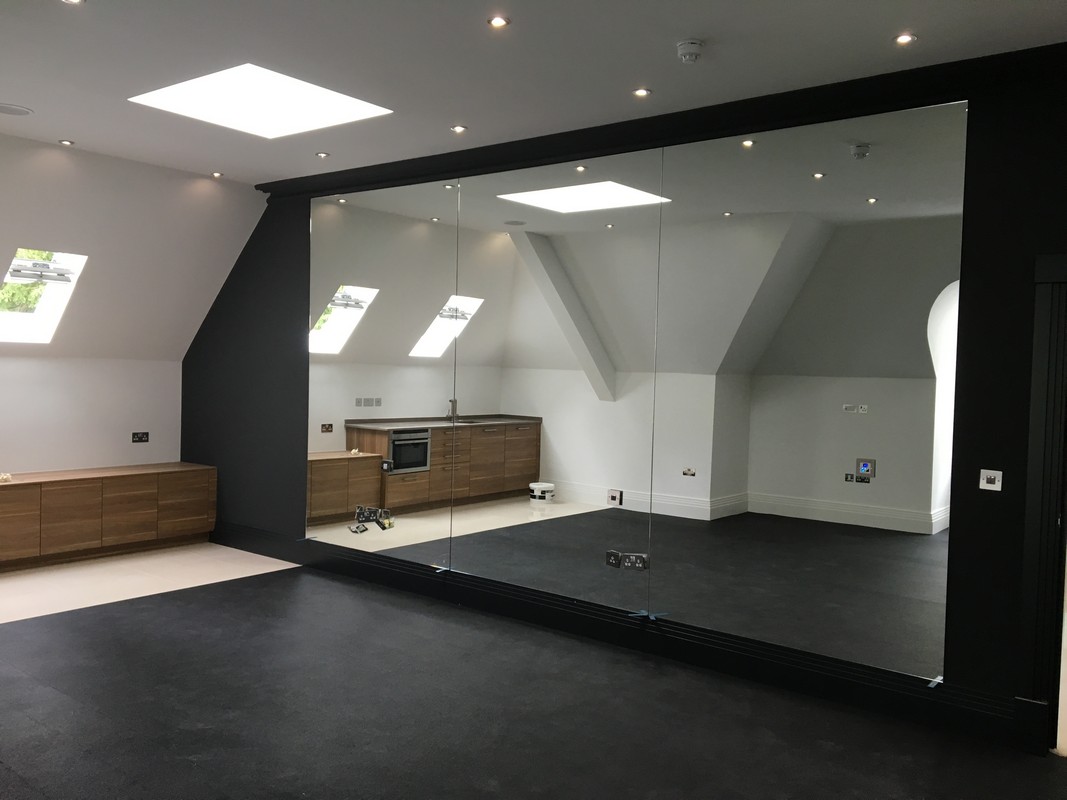Frameless glass wall dividing loft conversion in Chelsea