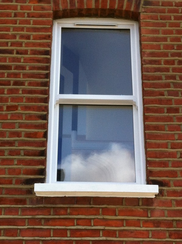 uPVC sash window on Victorian red brick house in Chelsea